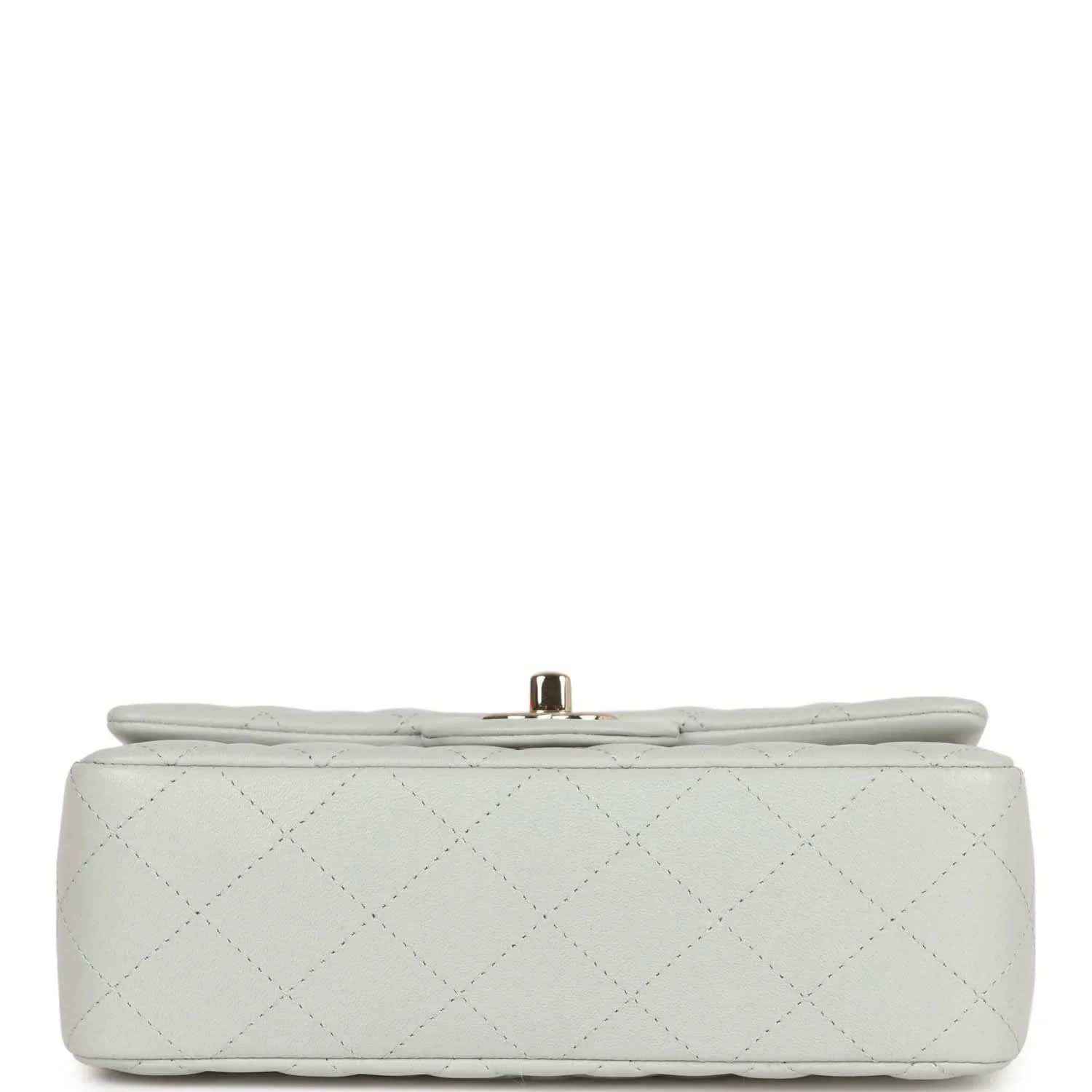Light grey quilted mini flap bag bottom view with small gold-tone post clasp