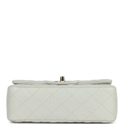 Light grey quilted mini flap bag bottom view with small gold-tone post clasp
