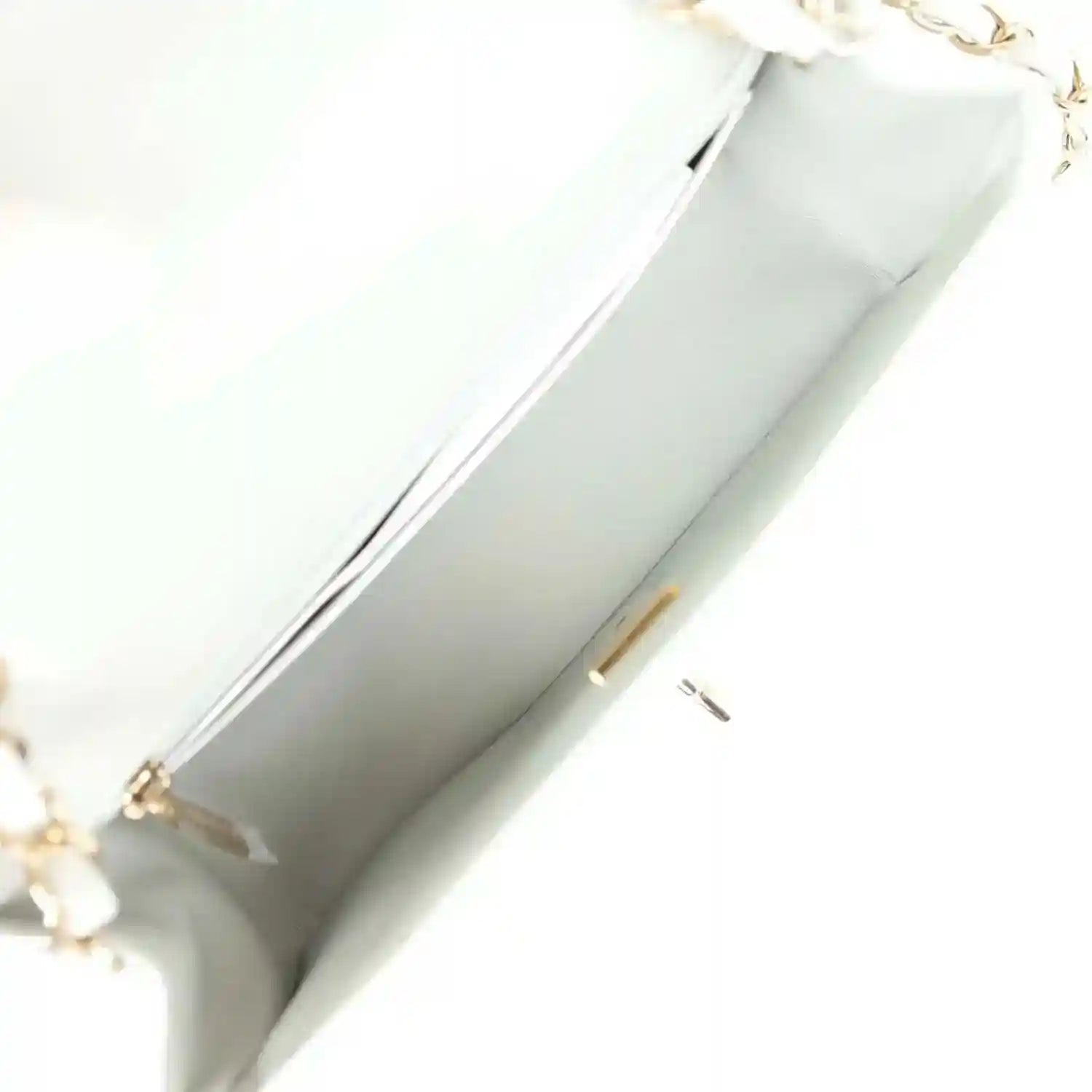 Light grey mini flap bag interior lining with zipper track and small pull tab