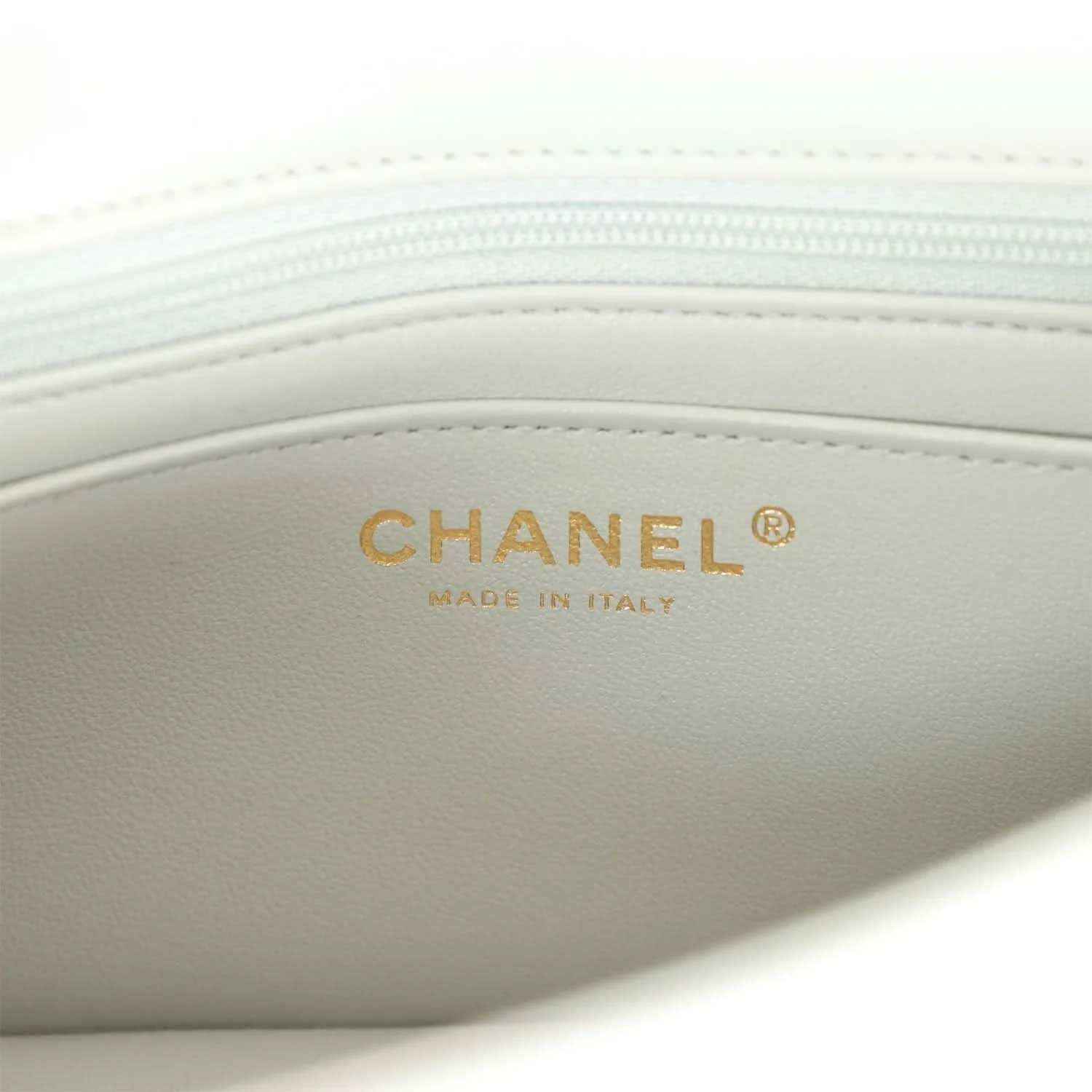 Light grey mini flap bag interior with CHANEL made in Italy label