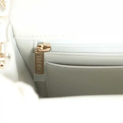 Light grey mini flap bag interior zipper pull with CHANEL engraving