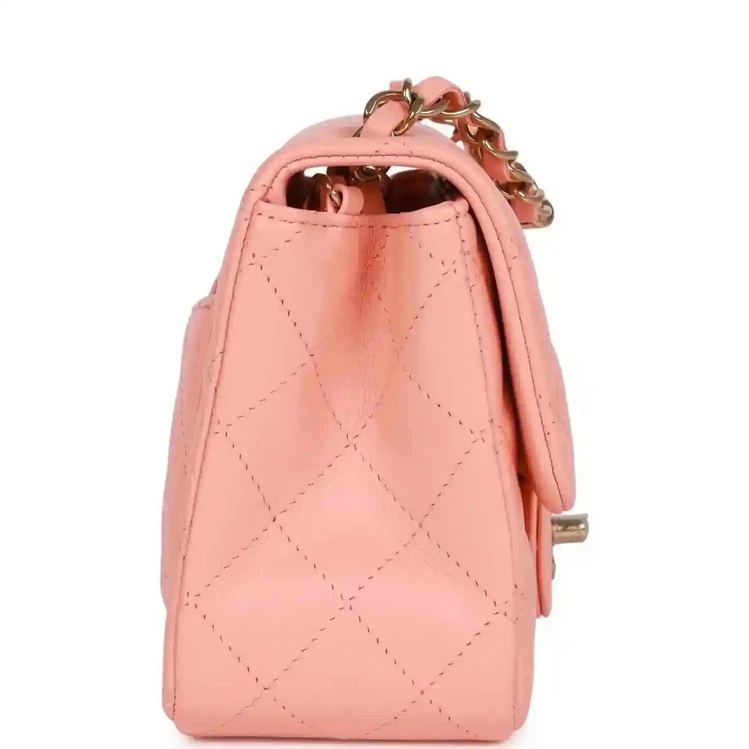 Pink quilted mini flap bag with gold chain, side view, and open top lining