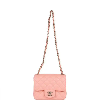 Pink quilted mini flap bag with long gold chain shoulder strap and Chanel clasp