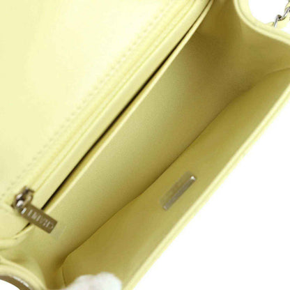 Lime lambskin mini flap bag interior with stitched lining and metal hardware