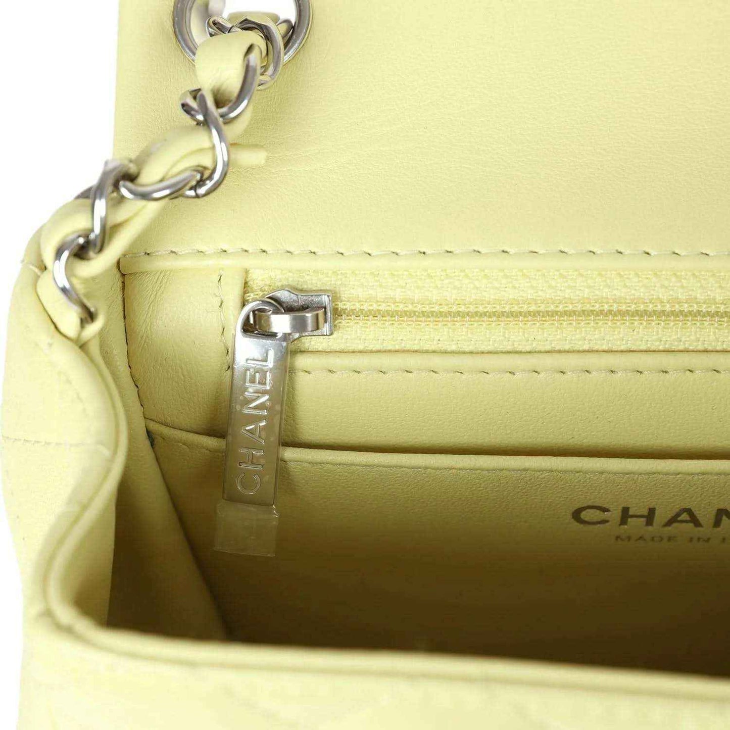 Lime lambskin mini flap bag interior with Chanel label and zipper pocket