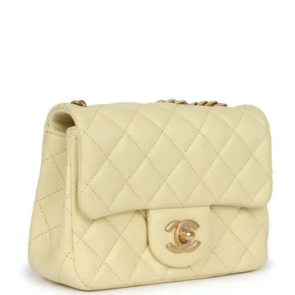Mini quilted flap bag in pale yellow leather with gold CC turn-lock and shoulder chain