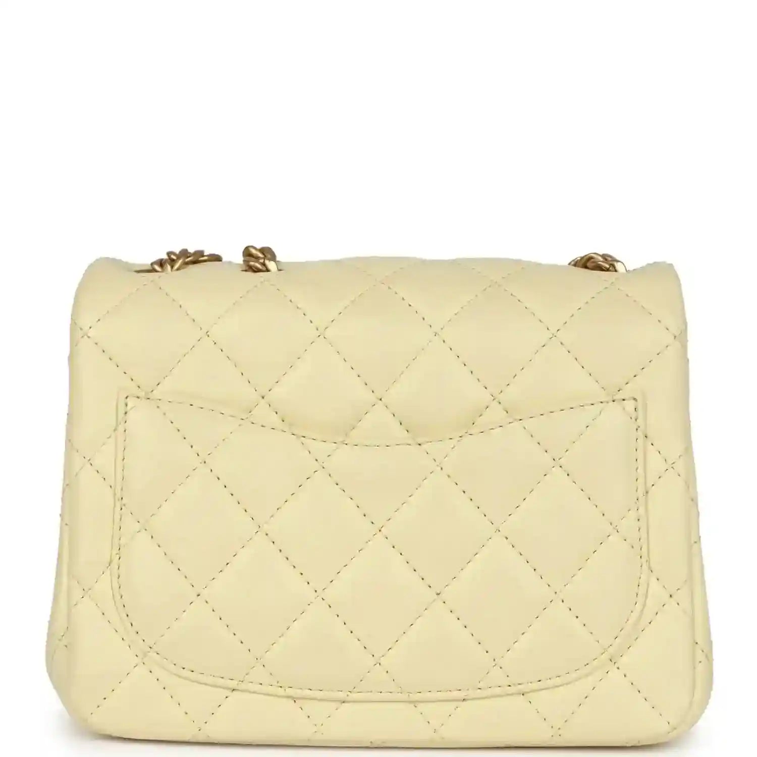 Mini quilted flap bag in pale yellow leather with stitched pocket flap detail and gold top closure