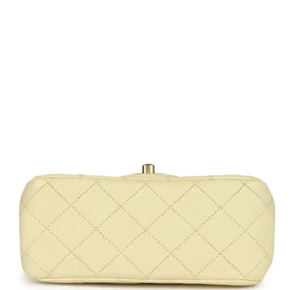 Mini quilted flap bag in pale yellow leather, back view with gold top clasp