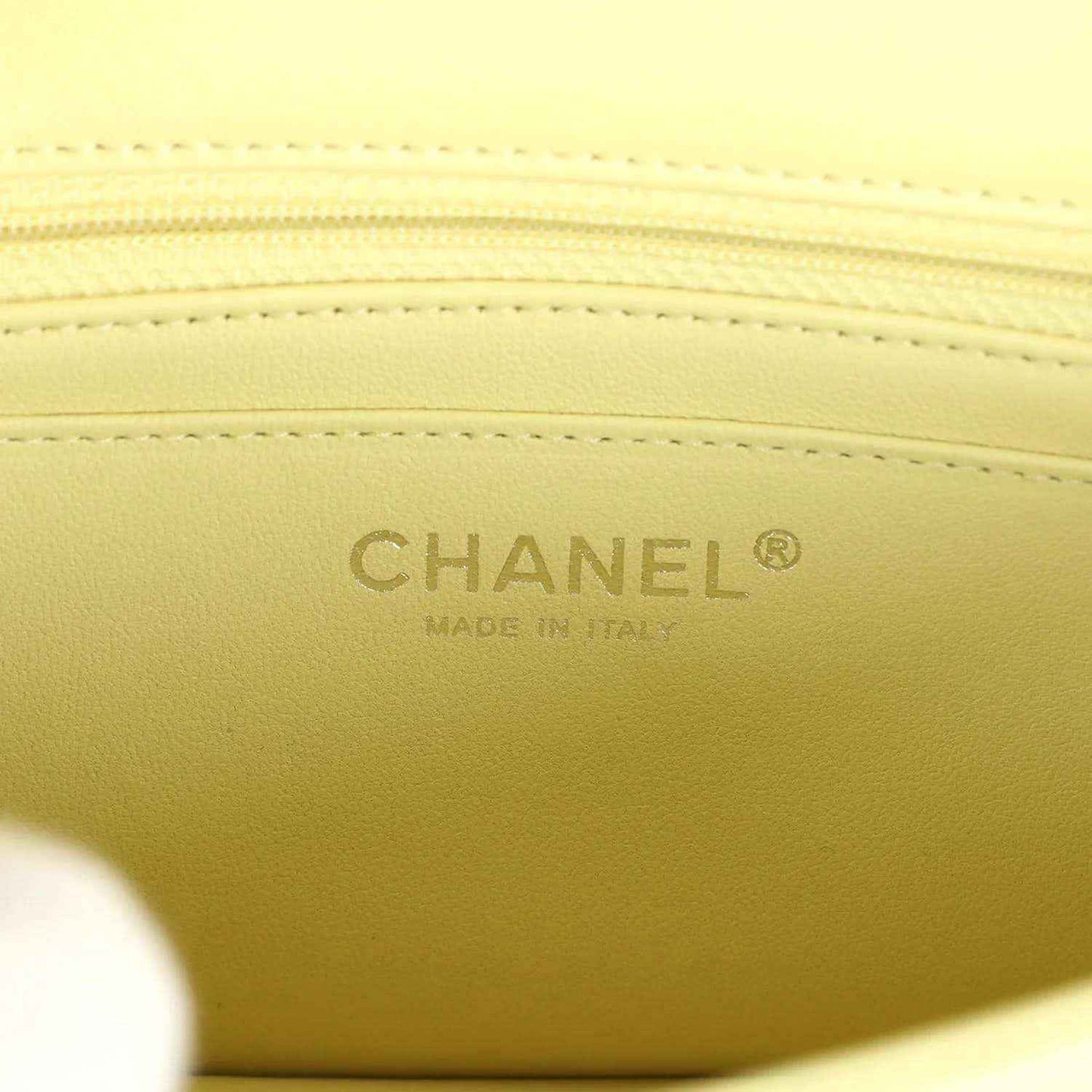 Lime mini flap bag lining with embossed CHANEL logo and Made in Italy text