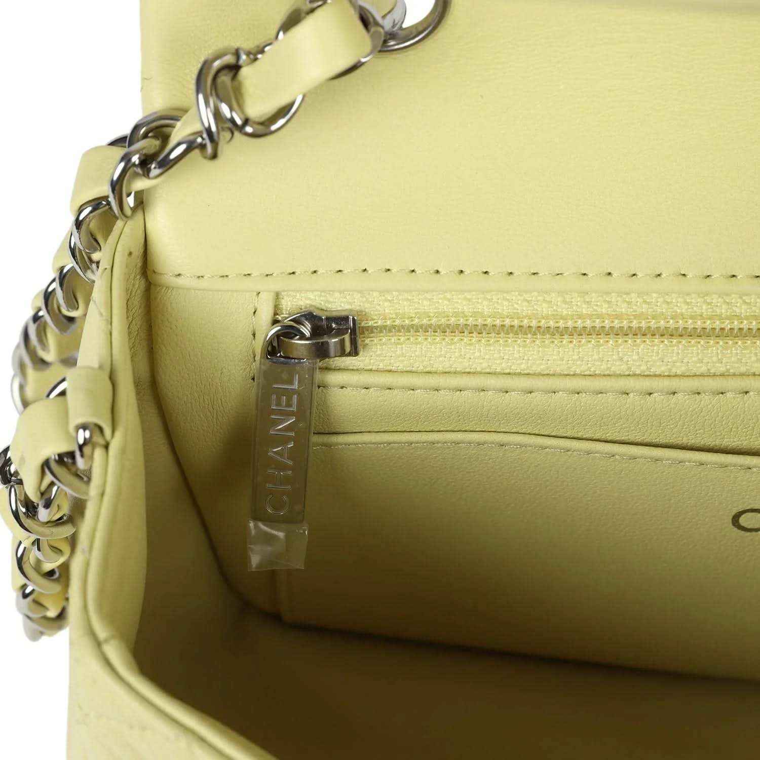 Lime mini flap bag interior pocket with zipper and vertical CHANEL tag detail