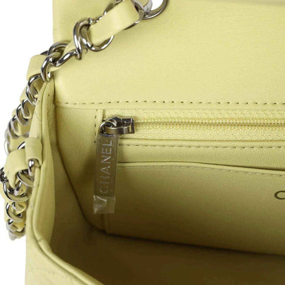 Lime mini flap bag interior pocket with zipper and vertical CHANEL tag detail