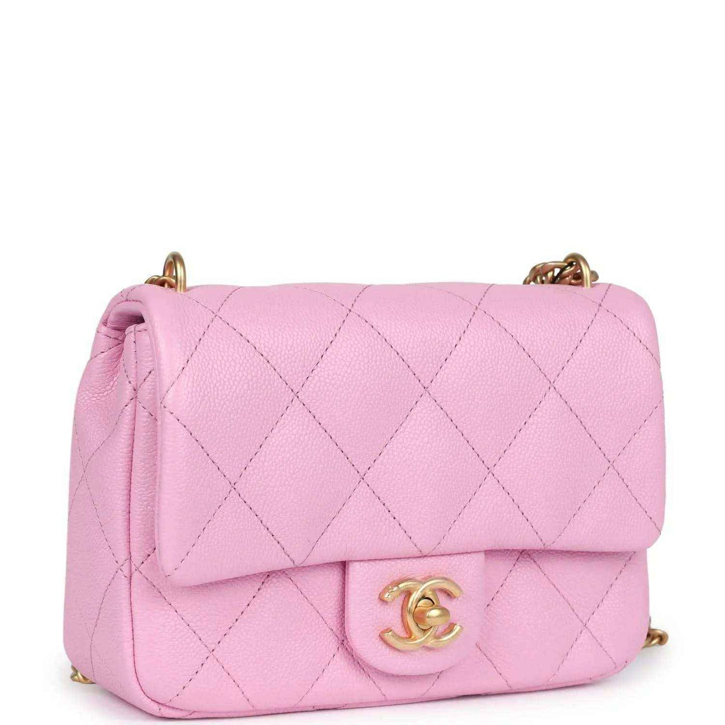 Pink mini flap bag with diamond-quilted texture, centered CC turn-lock and chain straps
