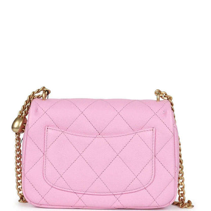 Pink mini flap bag with diamond quilting and exterior patch pocket with CC clasp