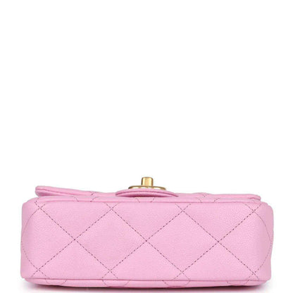 Pink mini flap bag bottom view with gold top turn-lock and diamond-quilted leather