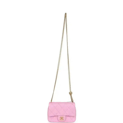 Pink mini flap bag with chain strap, small front flap, and CC logo turn-lock