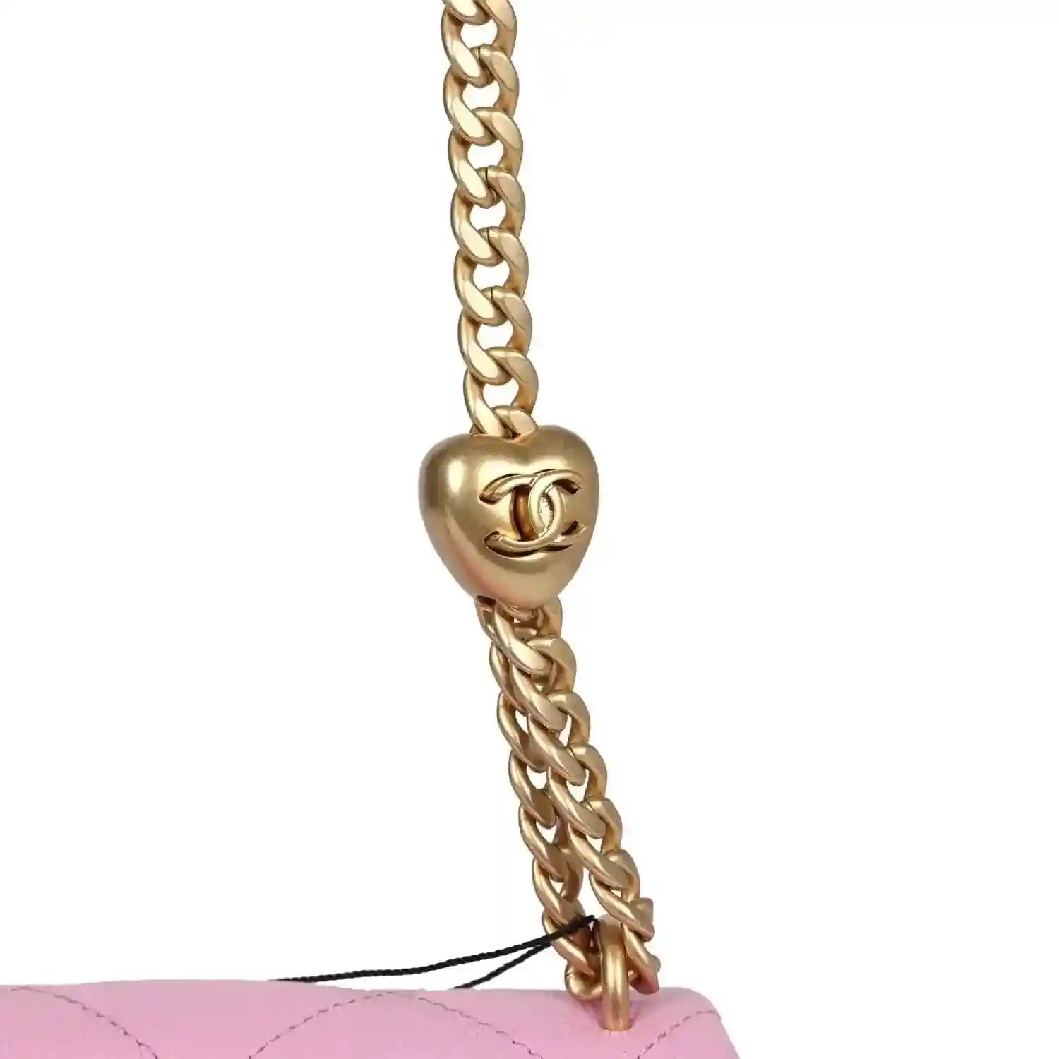 Gold CC charm on chain attached to pink mini flap bag with diamond-quilted leather