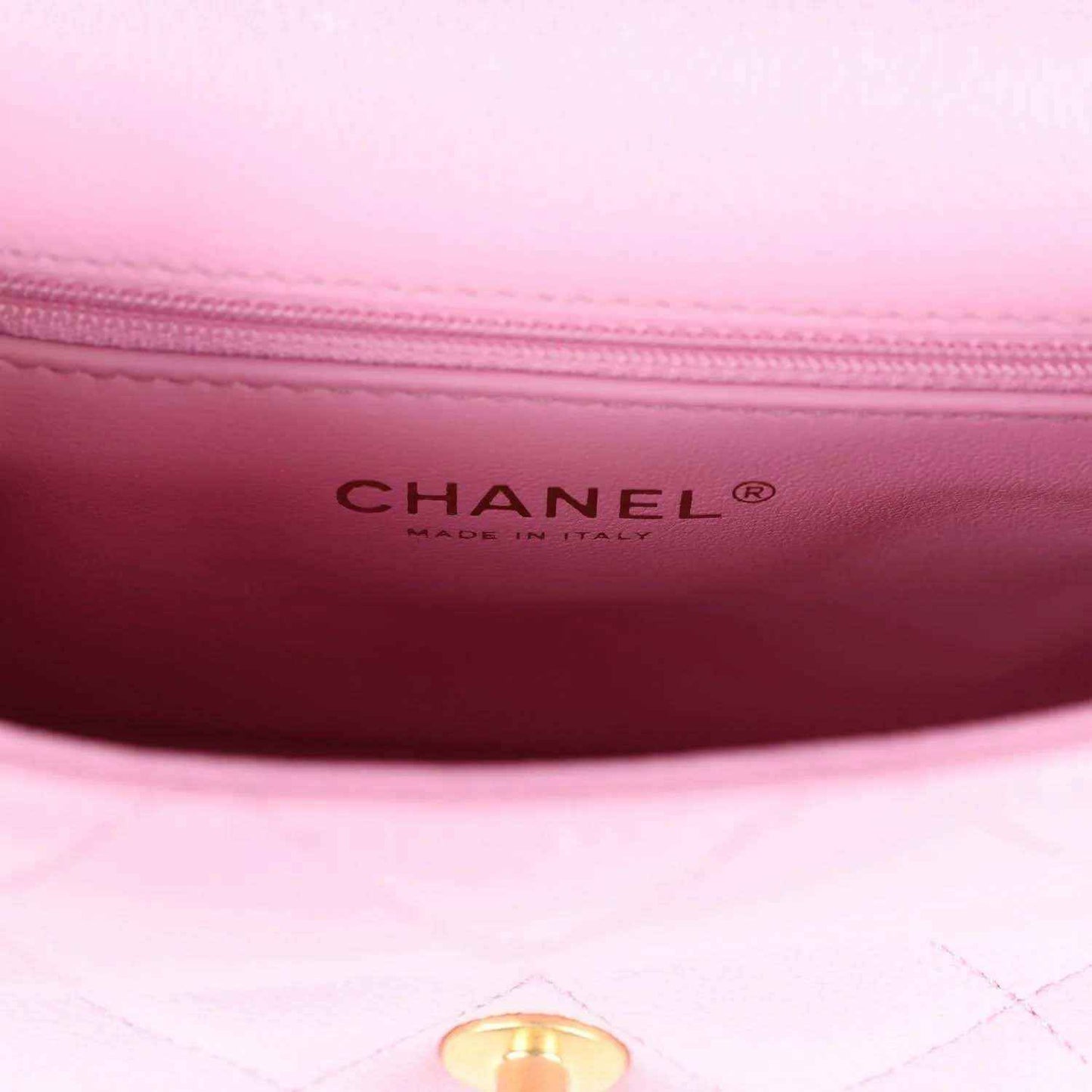 Pink leather interior with CHANEL brand stamp and quilted lining edge