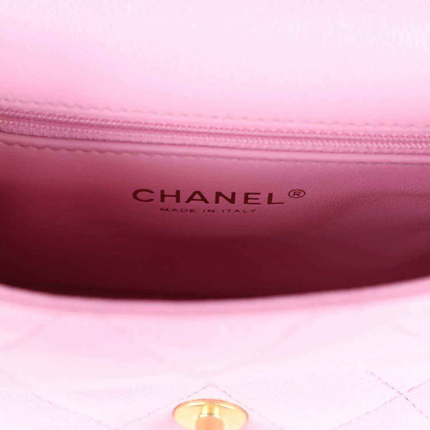 Pink leather interior with CHANEL brand stamp and quilted lining edge