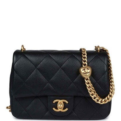 Mini quilted flap bag in black leather with gold chain and CC turn-lock.