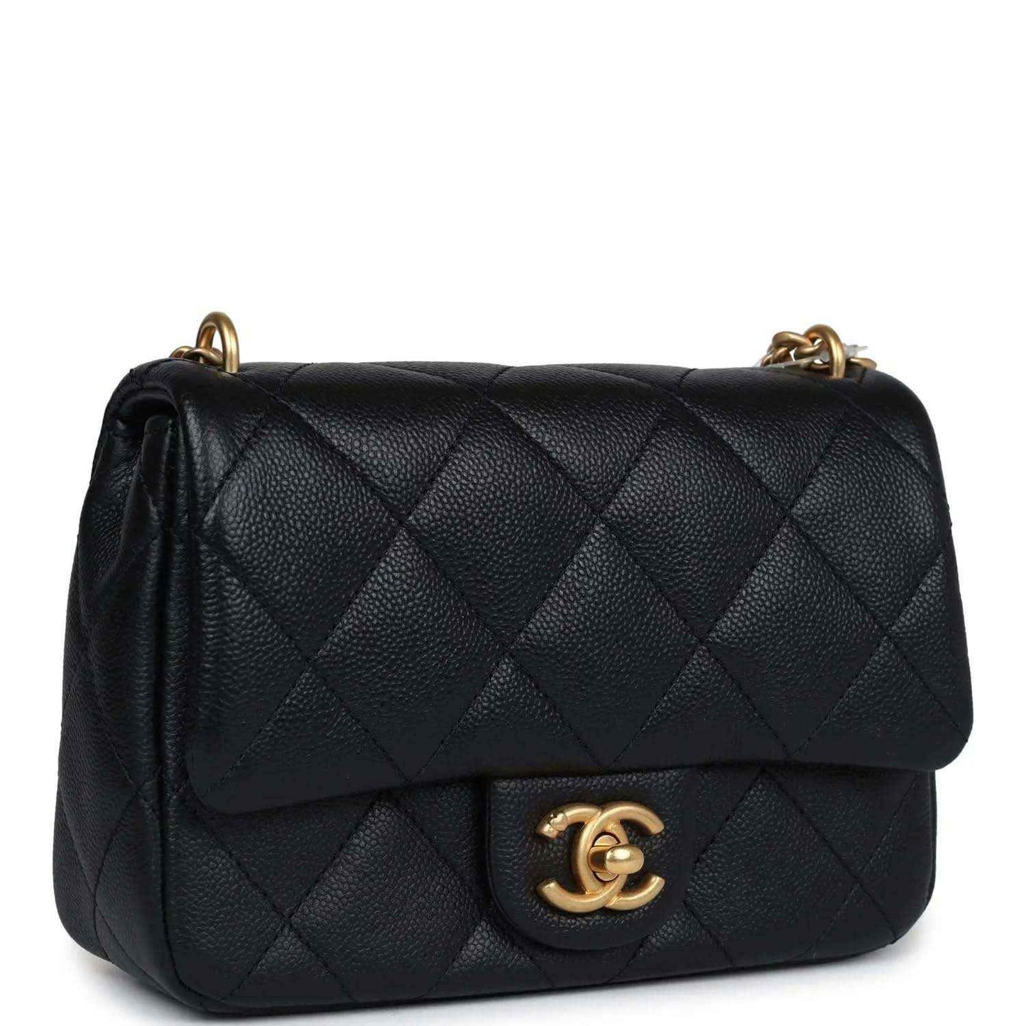 Mini quilted flap bag in black leather with gold CC emblem and chain strap.