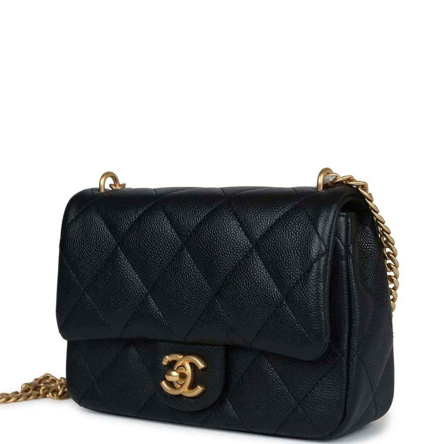Black quilted mini flap bag with gold CC medallion and shoulder chain strap.