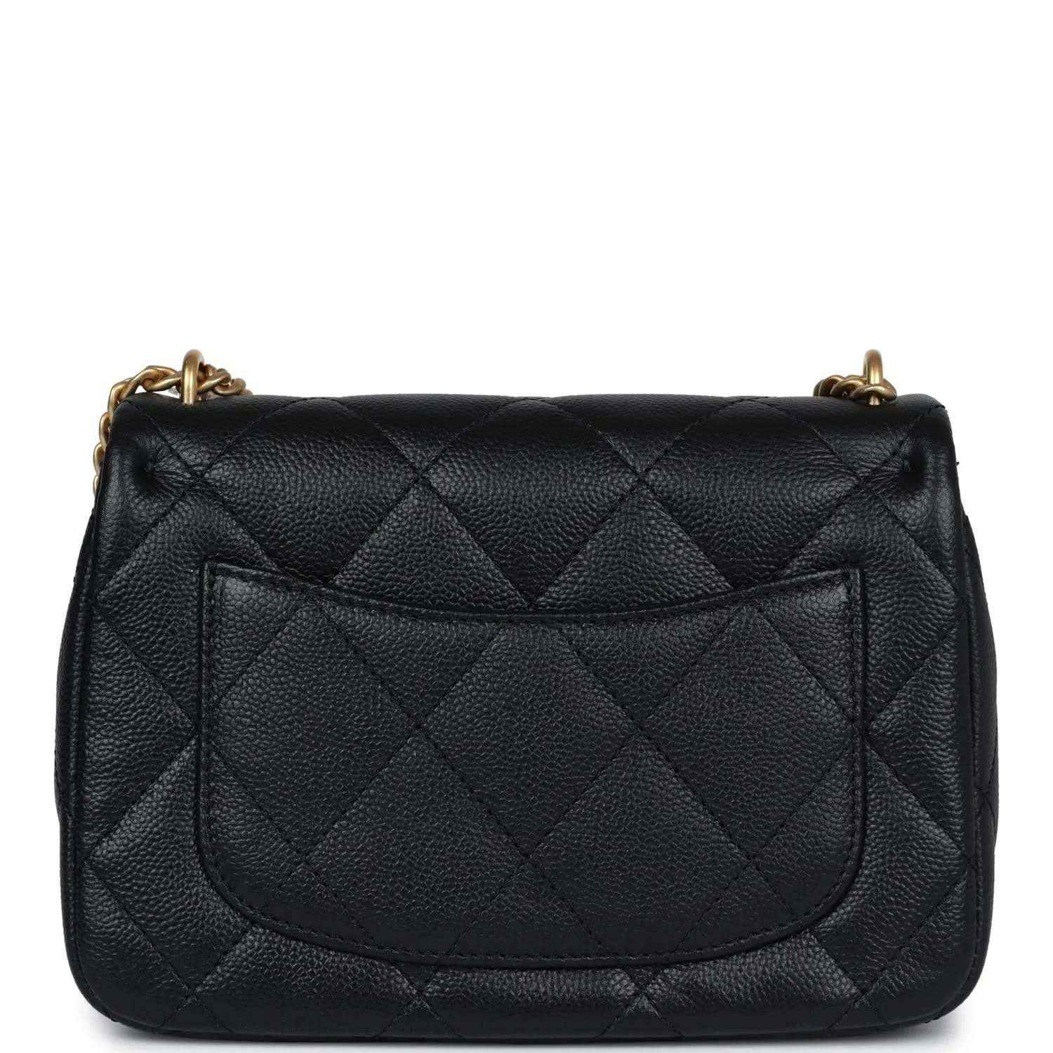Black quilted mini flap bag with gold-tone chain and stitched rear flap panel.
