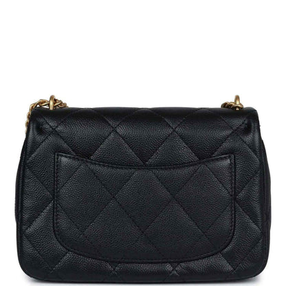 Black quilted mini flap bag with gold-tone chain and stitched rear flap panel.