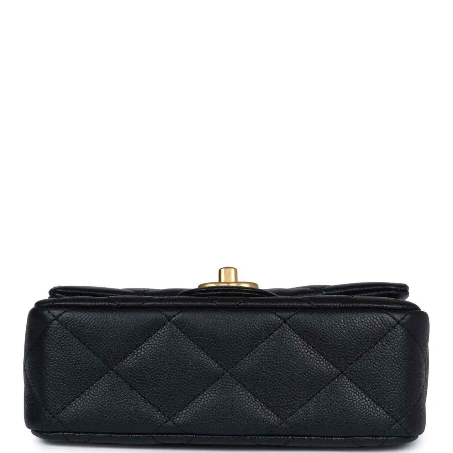 Black quilted mini flap bag top view with gold-tone button hardware.