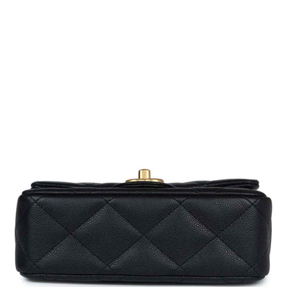 Black quilted mini flap bag top view with gold-tone button hardware.
