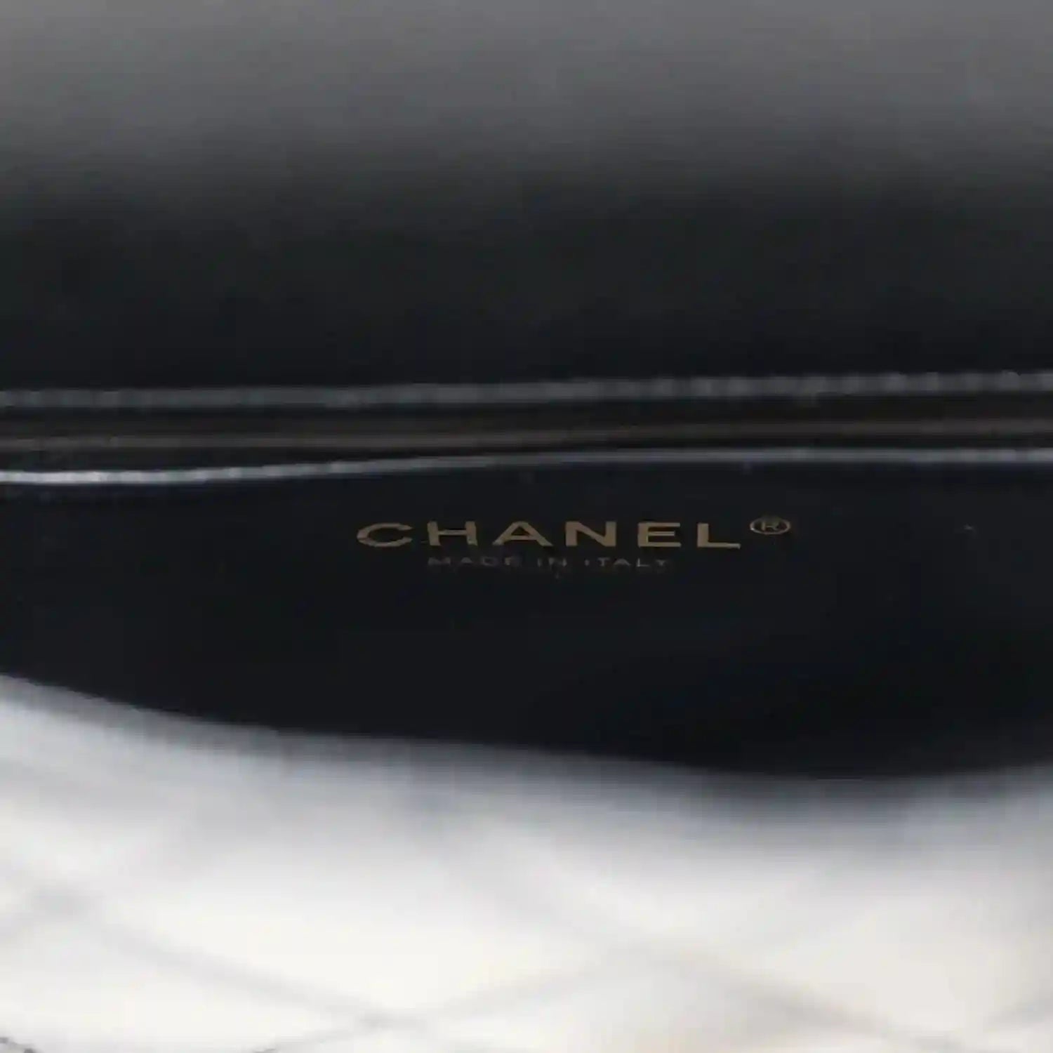 CHANEL logo on black lining of mini flap bag.