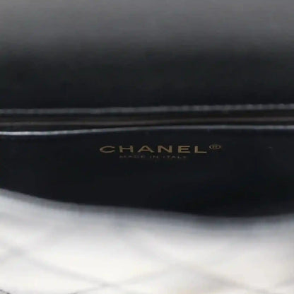CHANEL logo on black lining of mini flap bag.