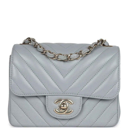Light grey mini shoulder bag with chevron quilting, flap, and gold-tone CC clasp