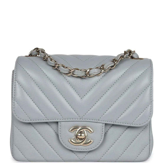 Light grey mini shoulder bag with chevron quilting, flap, and gold-tone CC clasp