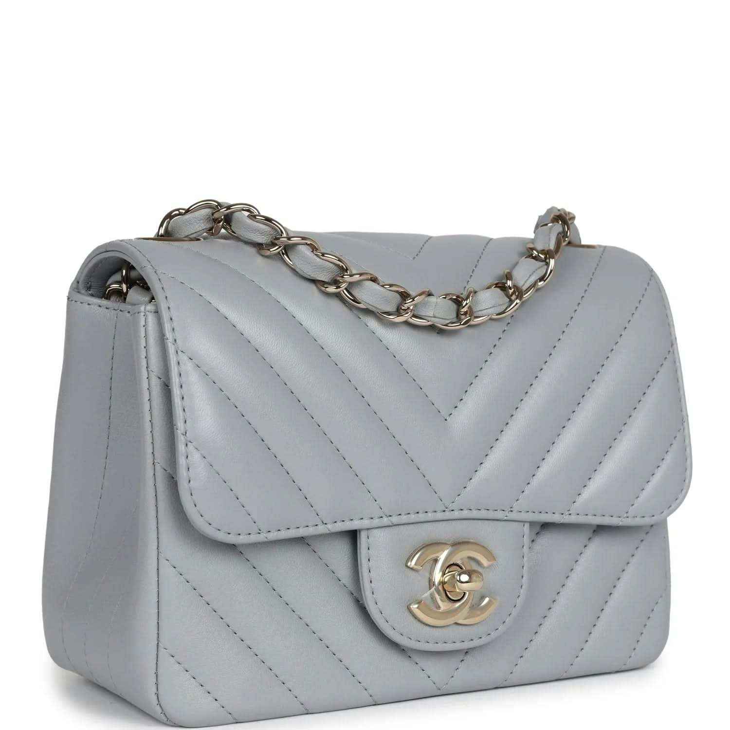 Light grey mini shoulder bag with flap, chevron quilting, and gold-tone chain strap