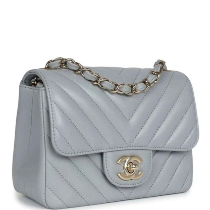 Light grey mini shoulder bag with flap, chevron quilting, and gold-tone chain strap
