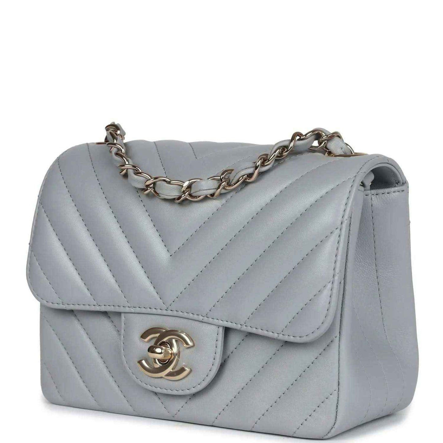 Light grey mini shoulder bag with flap, chevron stitching, and gold-tone CC logo clasp