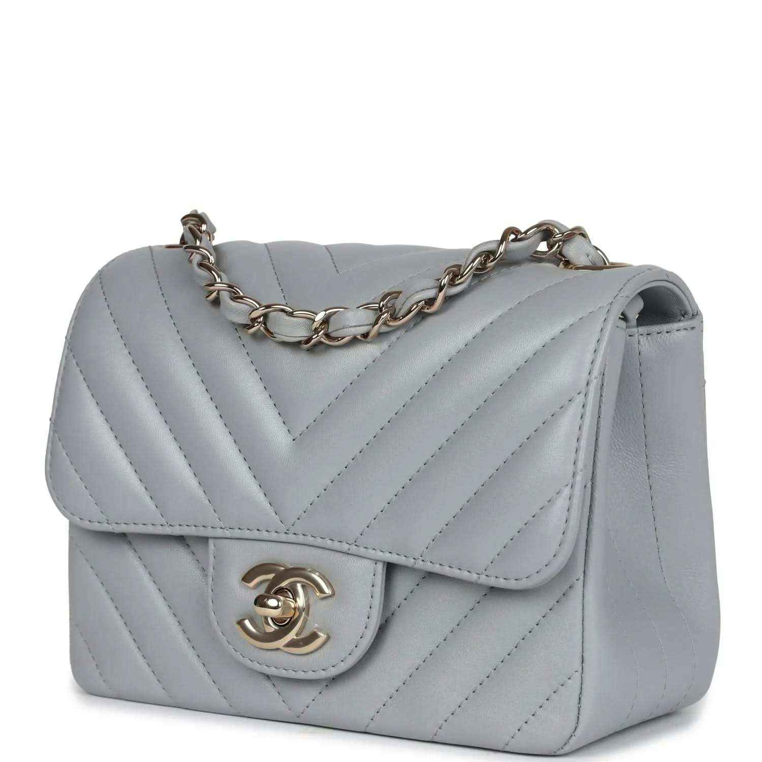 Light grey mini shoulder bag with flap, chevron stitching, and gold-tone CC logo clasp