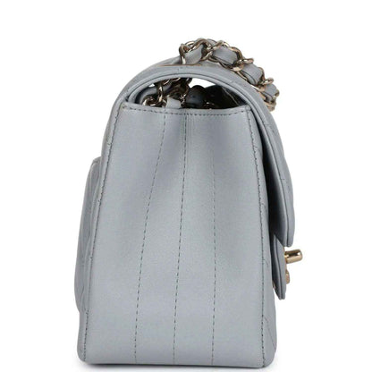 Light grey mini shoulder bag back panel with vertical stitching and chain strap loop