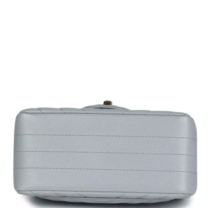Light grey mini shoulder bag base with stitched panels and small metal feet