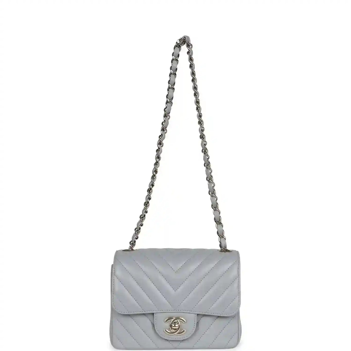Light grey mini shoulder bag with flap, chevron quilting, and chain strap