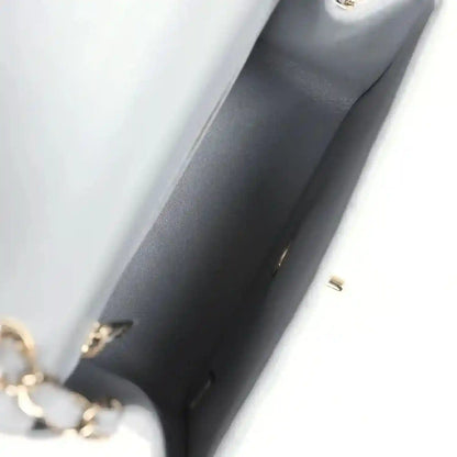 Light grey bag lining corner with gold-tone hardware and interior seam