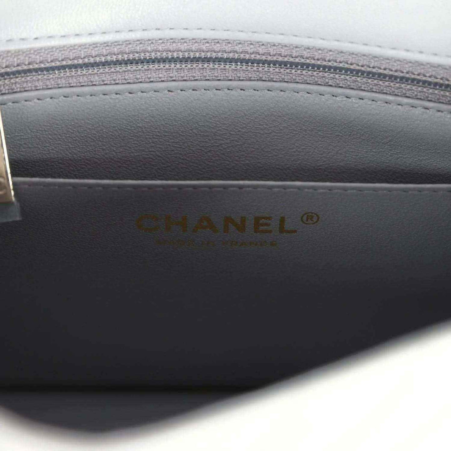 Dark grey lining with CHANEL logo on the mini bag interior