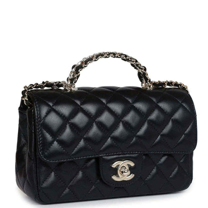 Mini flap bag in black quilted leather with curved chain handle and metal CC logo