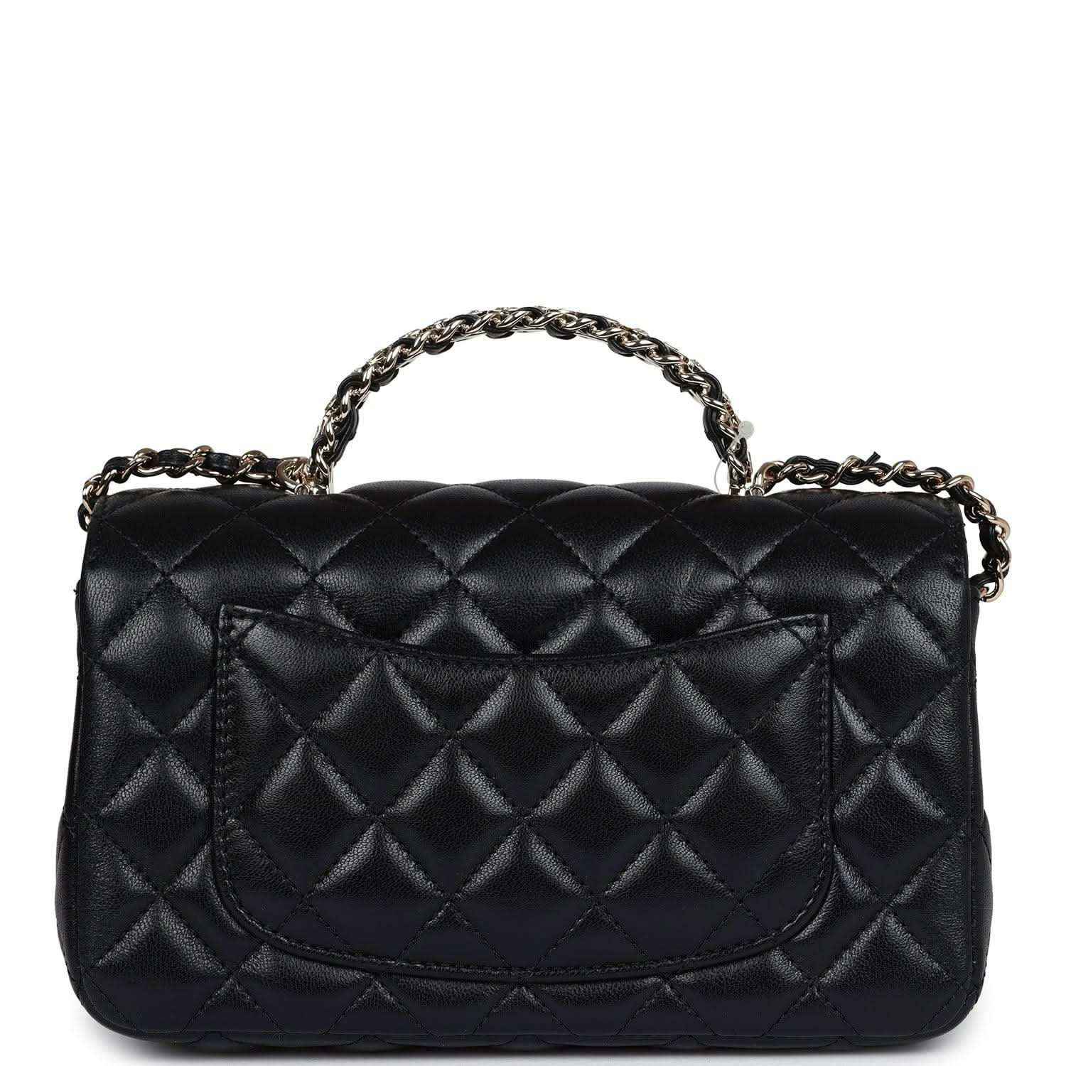 Mini rectangular flap bag in black quilted leather with top chain handle and curved flap