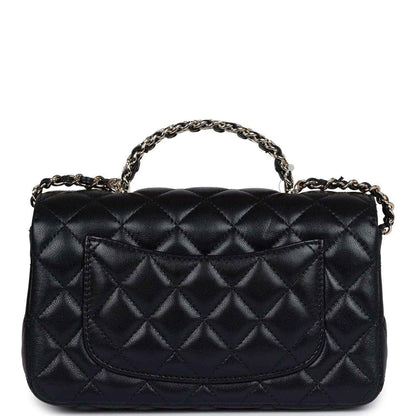 Mini rectangular flap bag in black quilted leather with top chain handle and curved flap