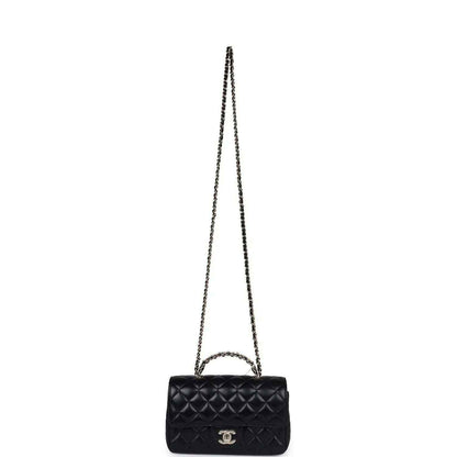 Mini black quilted flap bag with long chain strap and CC logo on front