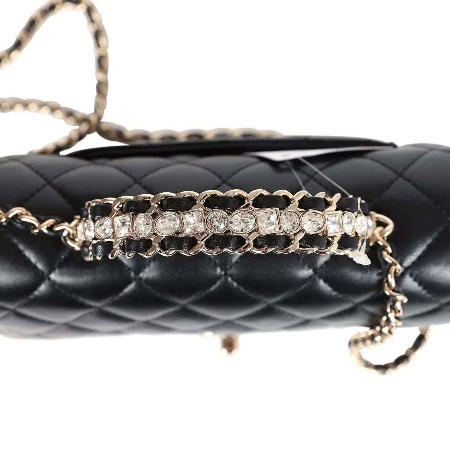 Close-up of quilted flap bag front with rhinestone chain and gold-tone hardware details