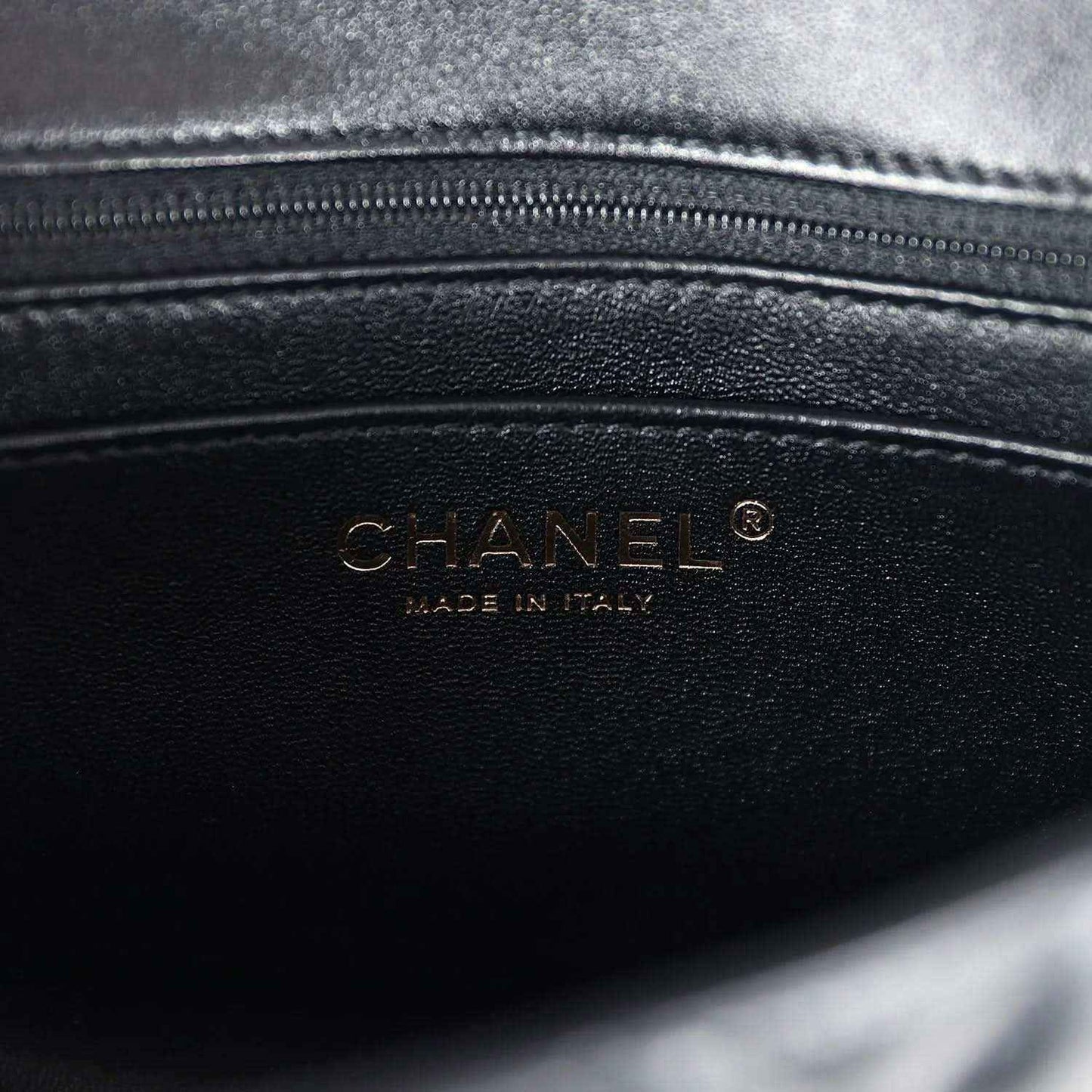 CHANEL leather logo stamp on black mini flap bag interior panel