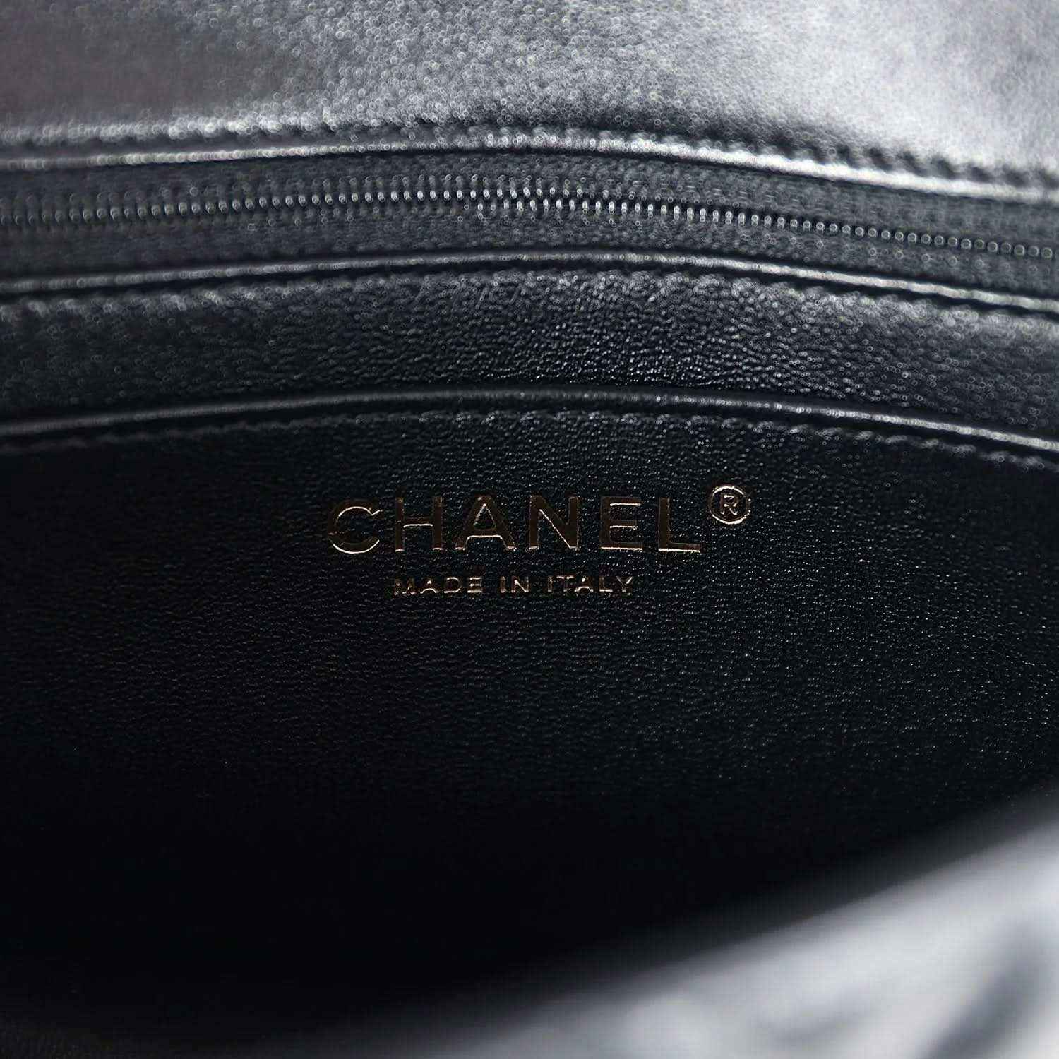 CHANEL leather logo stamp on black mini flap bag interior panel