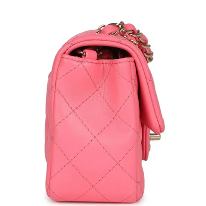 Hot pink quilted mini flap bag side view with gold-tone chain and logo hardware